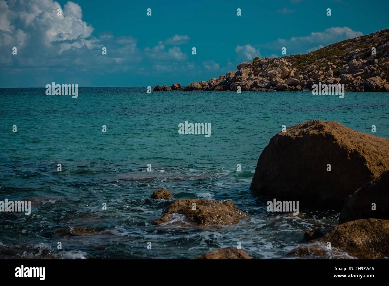 Big lone rock in water on the Imgiebah beach on Malta. Nice beaches of malta and sunny weather