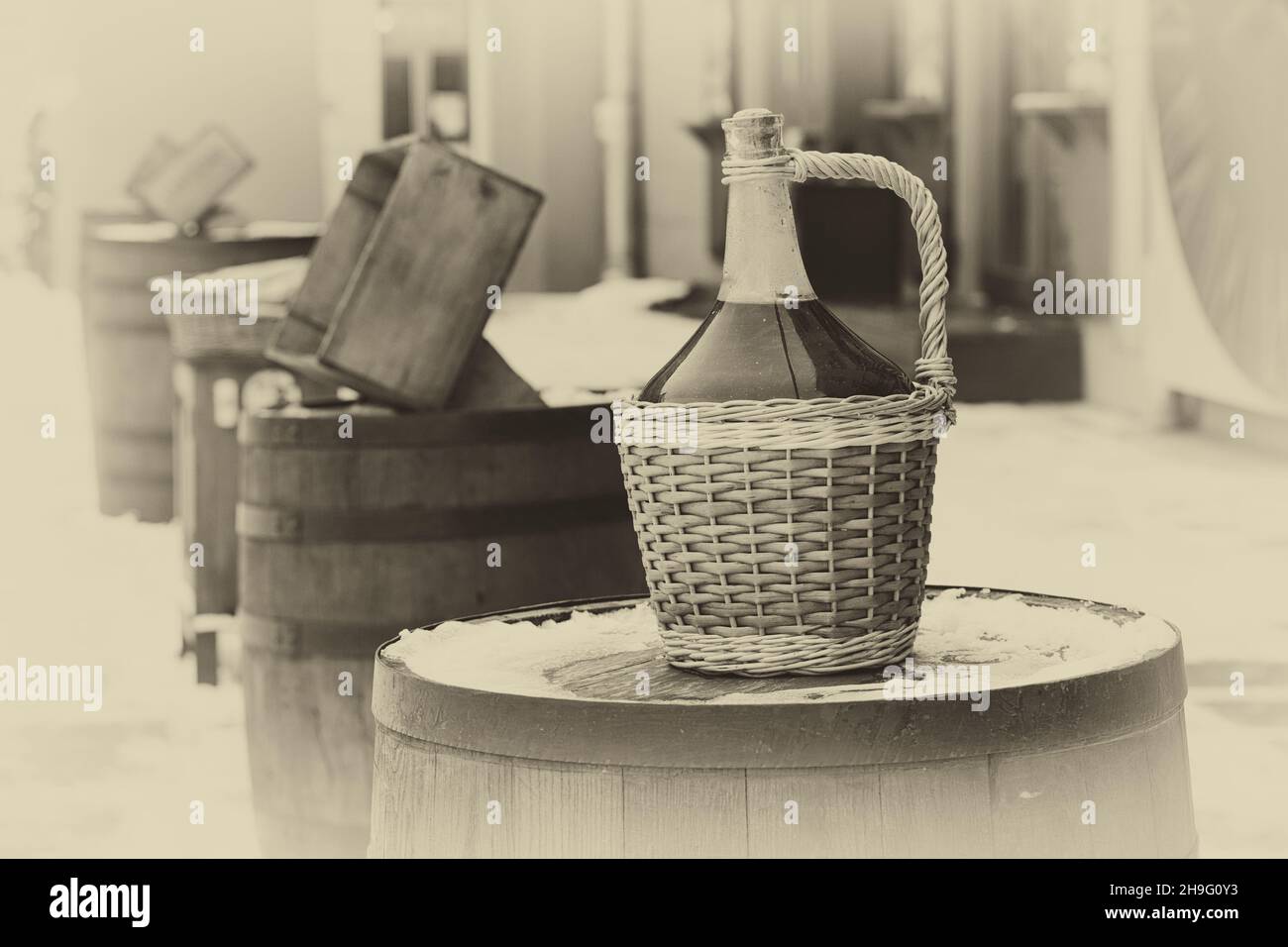 Bottle of red wine in wicker basket. Large Vintage Wine Bottles of red