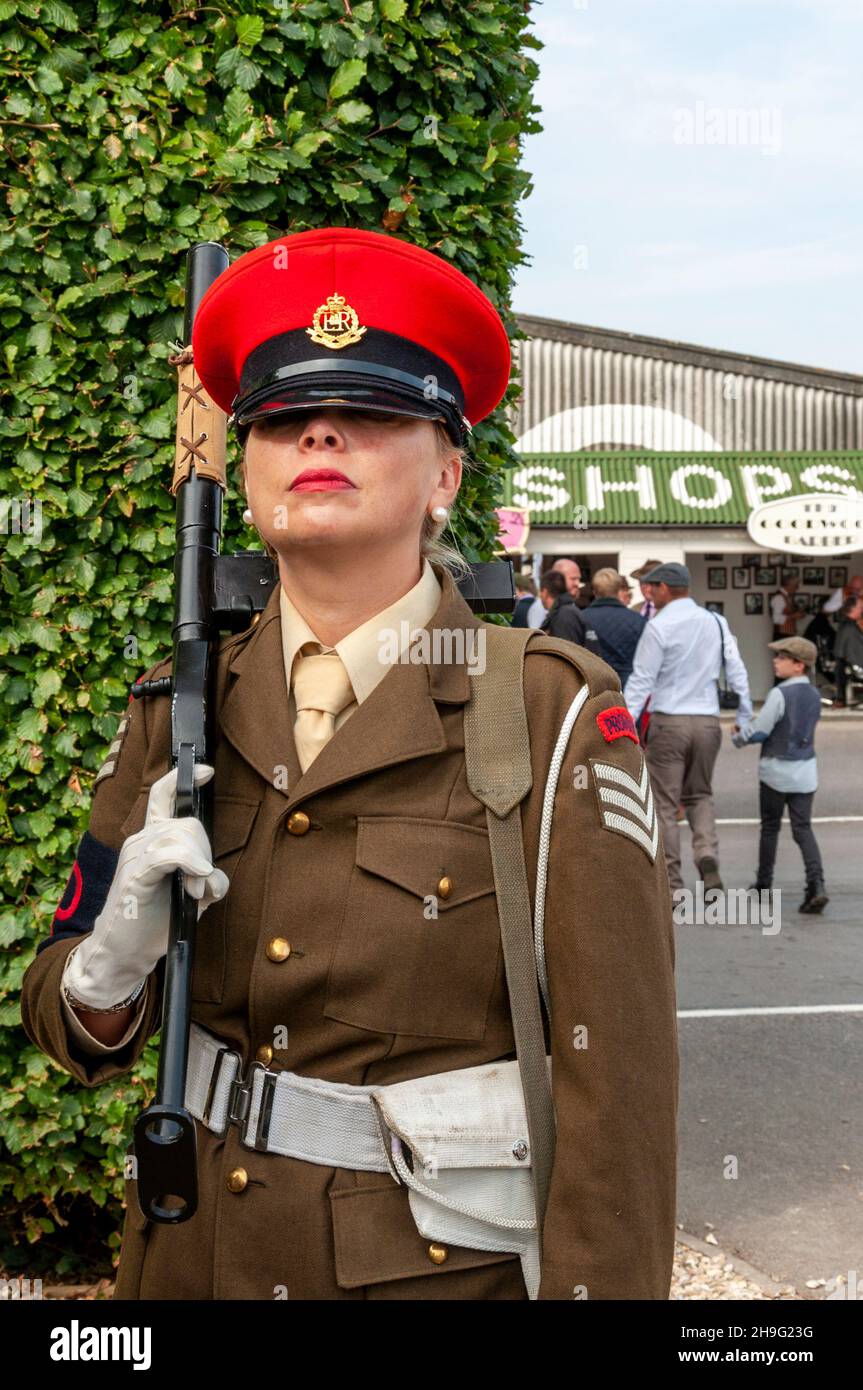 Female in vintage, period Military Police army costume with gun at the Goodwood Revival Stock Photo