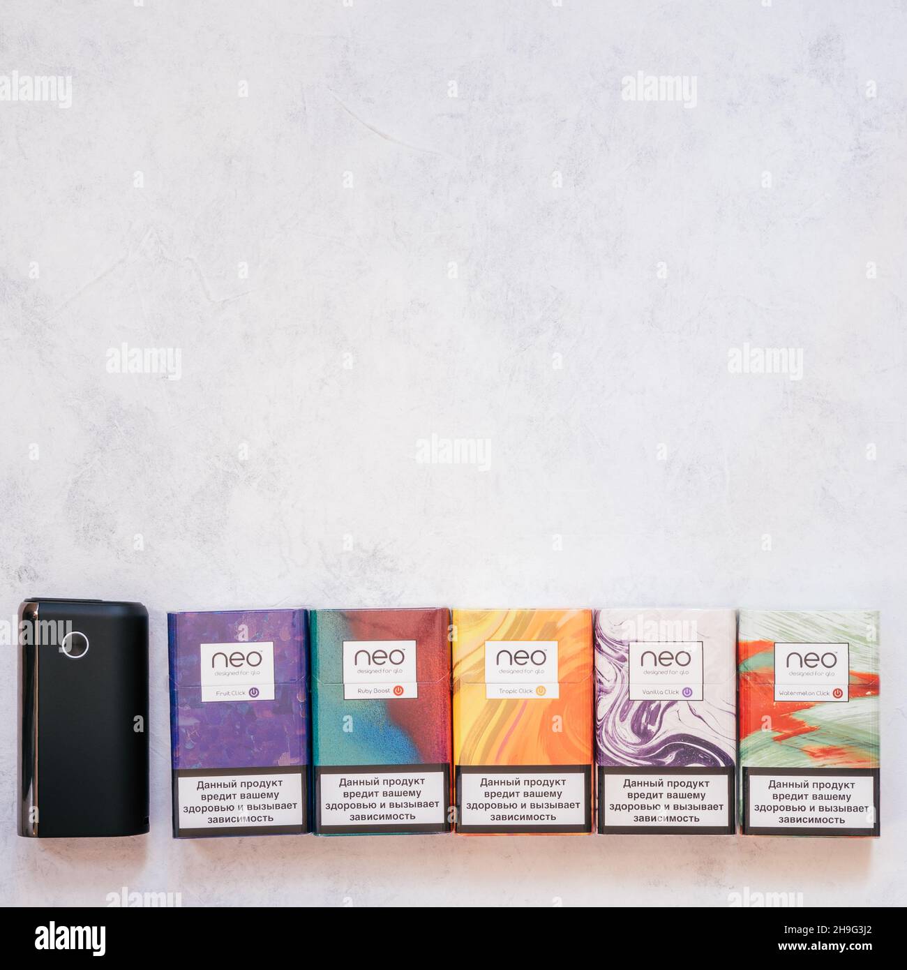 Packs of Neo smoking sticks with different flavors on white concrete