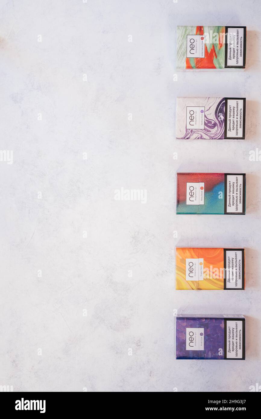 Packs of Neo smoking sticks with different flavors on white concrete  surface. Cigarettes for use with Glo heating device. Copy space. Flat lay.  Top vi Stock Photo - Alamy
