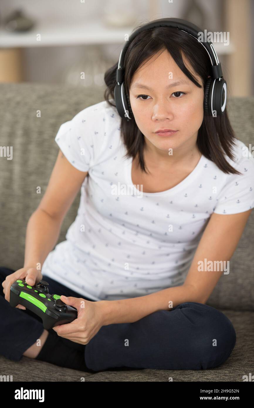 girl gamer in headphones and with a joystick Stock Photo Alamy
