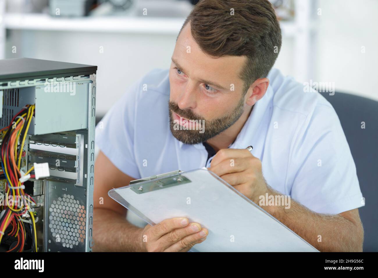 computer repairman working on repairing computer in it workshop Stock ...