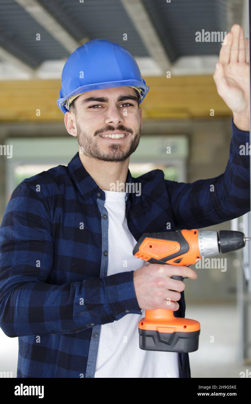 male construction worker using cordless powertool Stock Photo Alamy