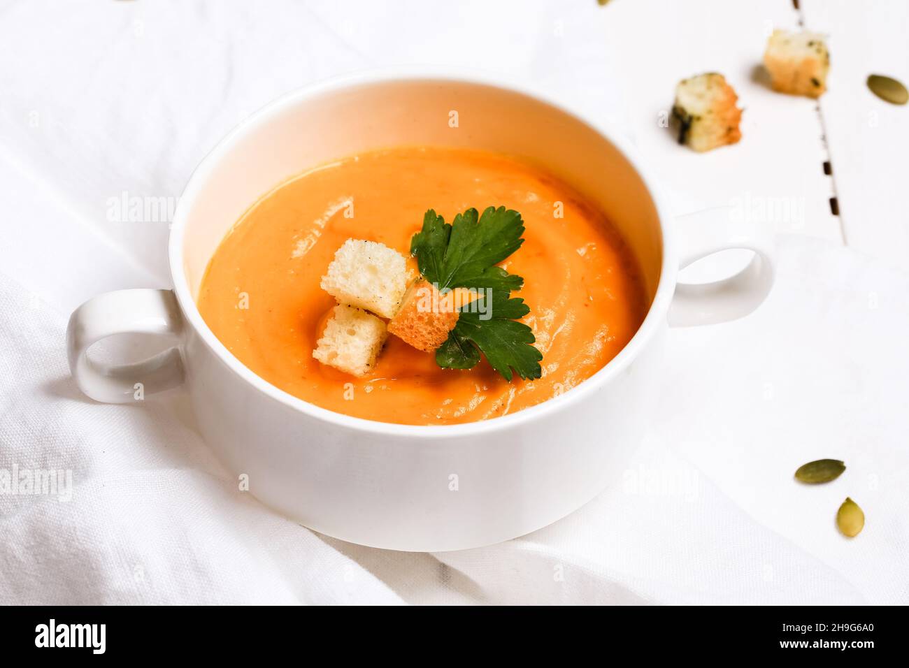 pumpkin soup with croutons on a white background Stock Photo - Alamy
