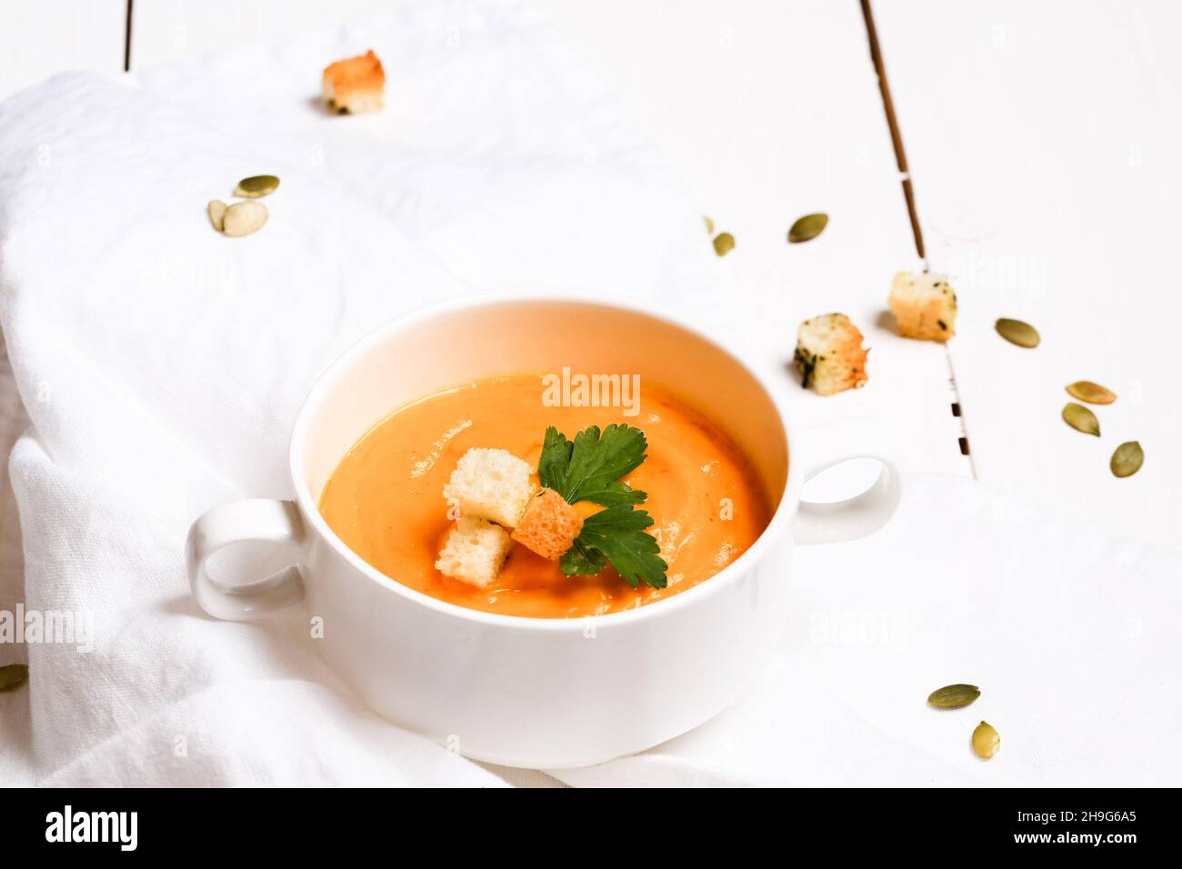 pumpkin soup with croutons on a white background Stock Photo - Alamy