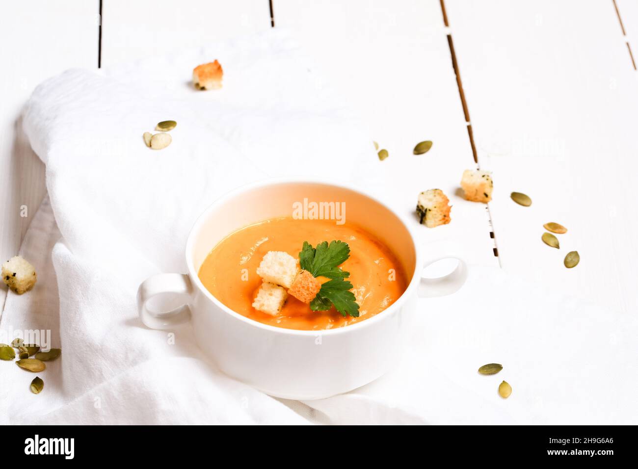 pumpkin soup with croutons on a white background Stock Photo - Alamy