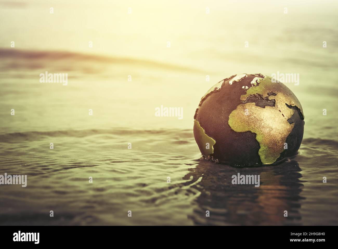 Globe in the water, climate change Stock Photo