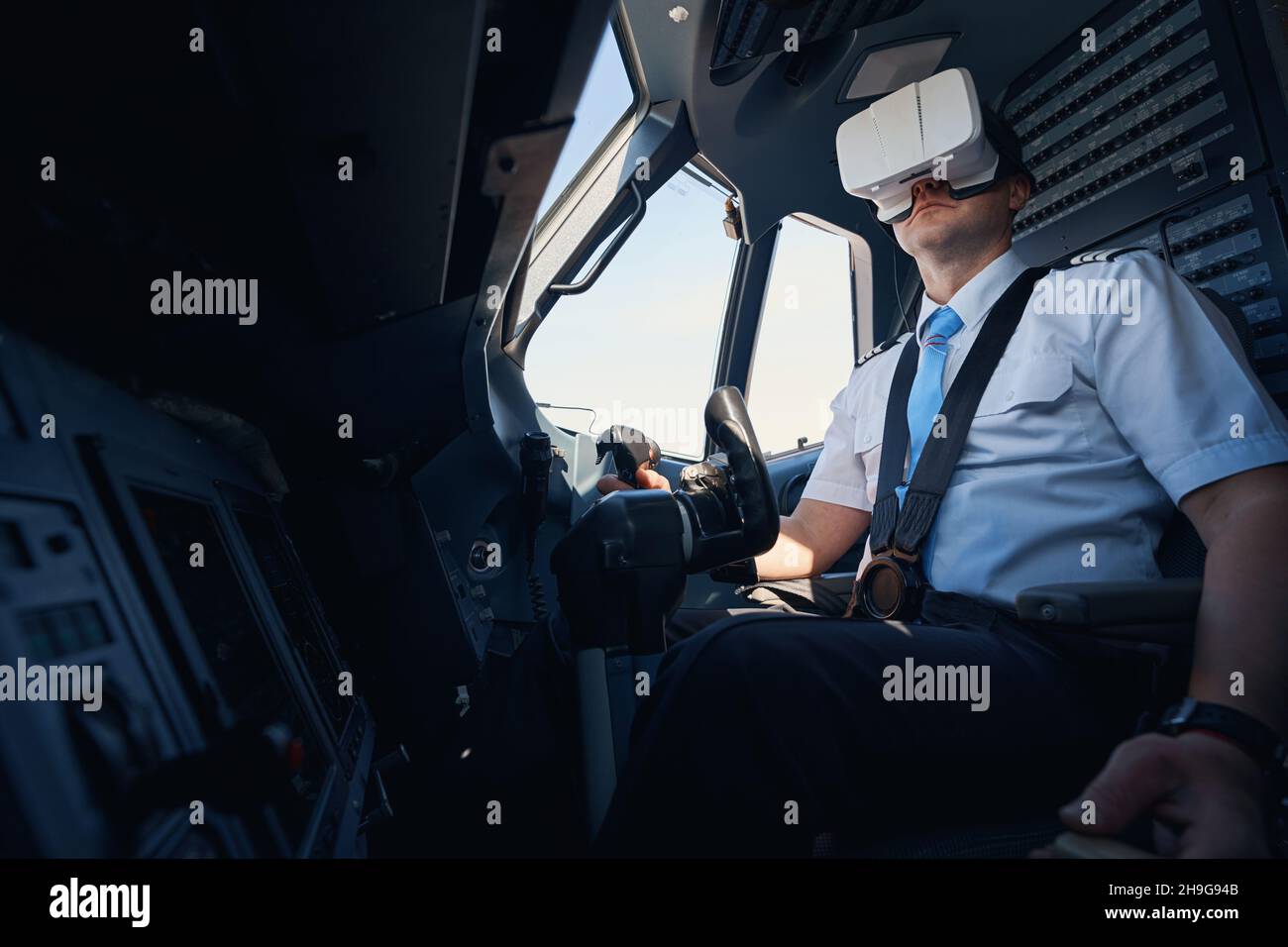 Man in augmented reality headset practising steering plane Stock Photo -  Alamy
