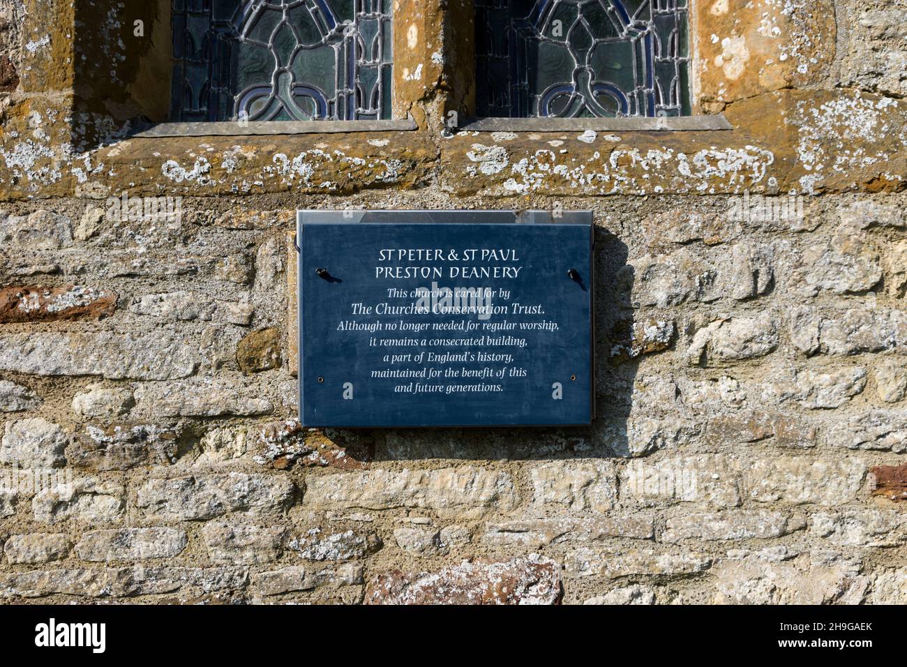 Churches Conservation Trust sign on the exterior of the church of St Peter and St Paul, Preston Deanery, Northamptonshire, UK Stock Photo