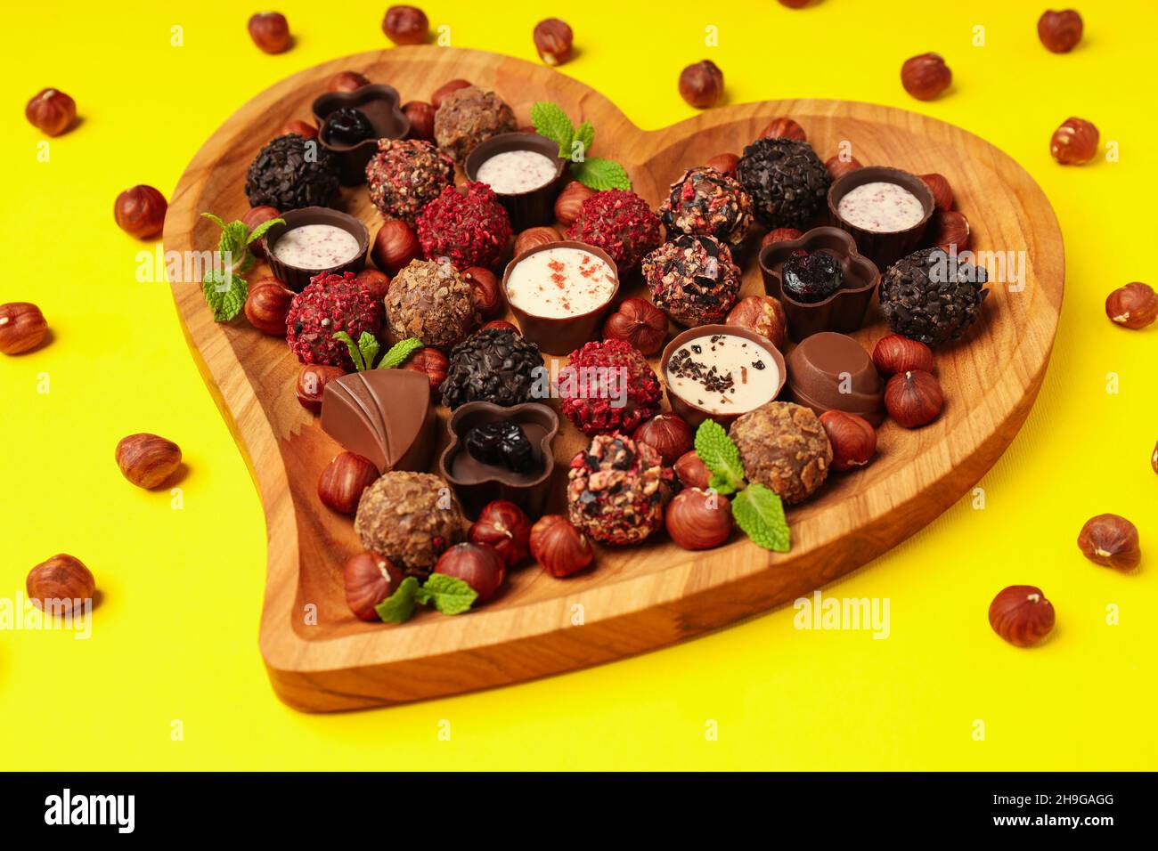Concept of sweets with chocolate candies on yellow background Stock