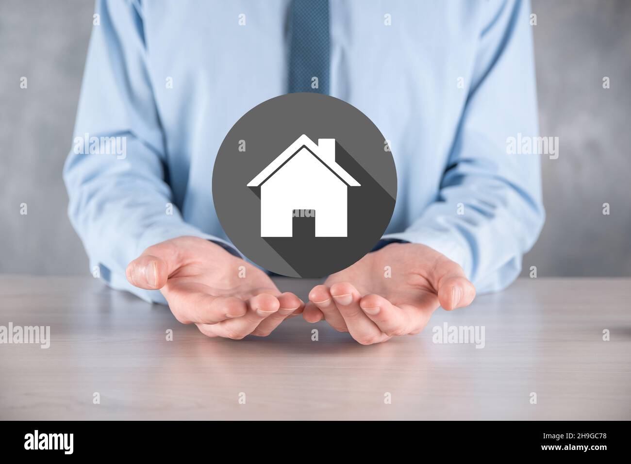 Real estate concept, businessman holding a house icon.House on Hand.Property insurance and security concept. Protecting gesture of man and symbol of h Stock Photo