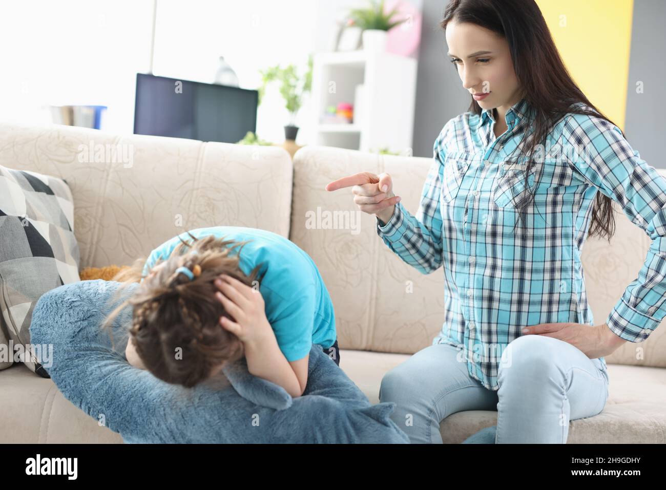 Millennial mother screaming shouting on little girl daughter Stock Photo