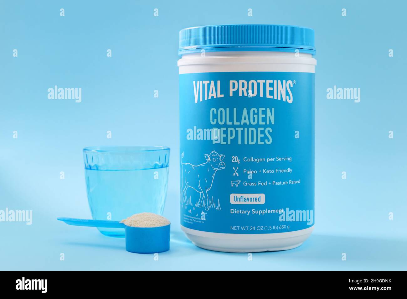 KIEV, UKRAINE-NOVEMBER 10, 2021: Collagen Peptides Powder Jar with a measuring spoon and a glass of water. Famous brand Vital Proteins. Collagen from Stock Photo