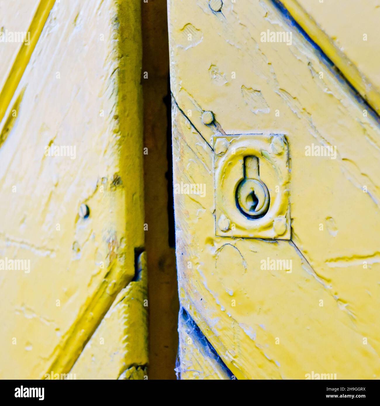 Closeup shot of lock in a yellow door Stock Photo - Alamy