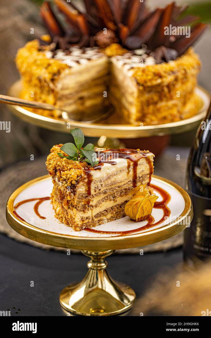 Slice of cake with crushed nuts and caramel topping Stock Photo
