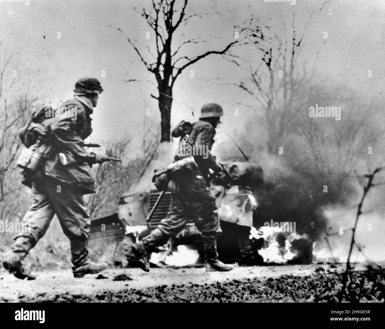 POTEAU, BELGIUM - 18 December 1944 - This image captured from the Nazis shows the Nazi Panzergrenadier-SS Kampfgruppe Hansen soldiers in action during Stock Photo