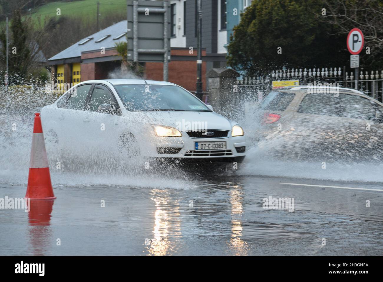 Bantry, West Cork, Ireland. 7th Dec, 2021. Bantry encounters yet another flooding, Cork County Council and Bantry Fire Brigade were on scene to prevent flooding even more. Pictured below are vehicles driving through floodwaters. Credit: Karlis Dzjamko/Alamy Live News Stock Photo