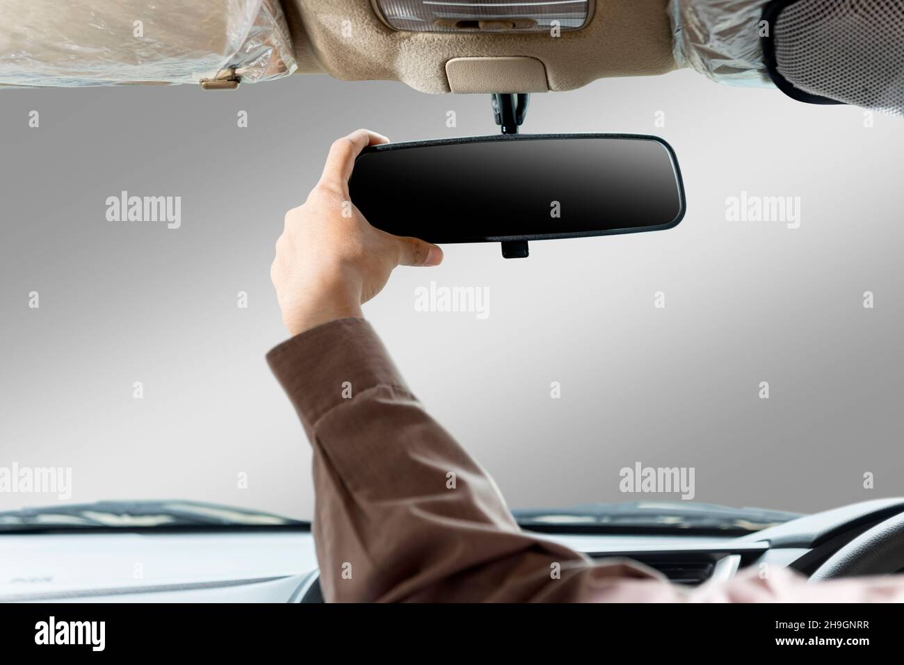 Hand adjusting rear view mirror inside the car Stock Photo Alamy