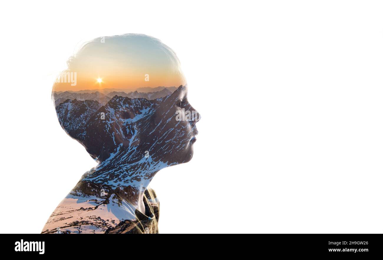 Isolated combination of the silhouette of a child face and a landscape with mountains. Concept of the connection between man and nature Stock Photo
