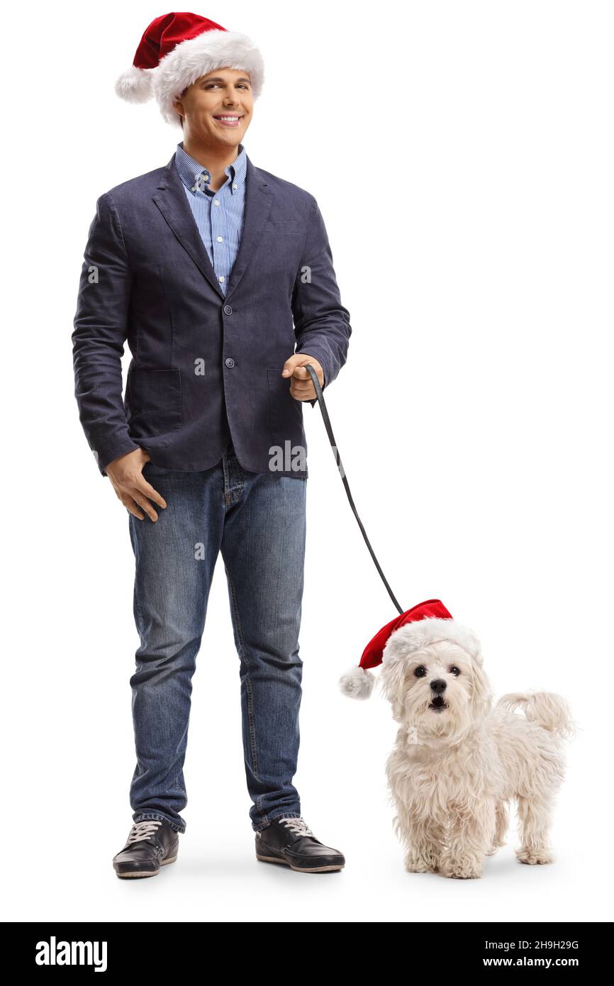 Full length portrait of a young man wearing a santa claus hat and ...