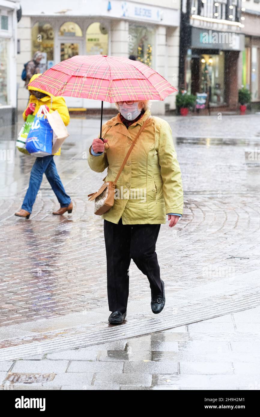 Hereford, Herefordshire, UK - Tuesday 7th December 2021 - UK Weather - Shoppers brave the strong winds and heavy rain in Hereford city centre as Storm Barra aprroaches from the West - Photo Steven May / Alamy Live News Stock Photo