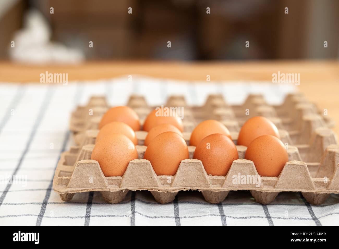 Few brown eggs among the cells of a large cardboard bag, chicken egg as a valuable nutritious product, a tray for carrying and storing fragile eggs. N Stock Photo