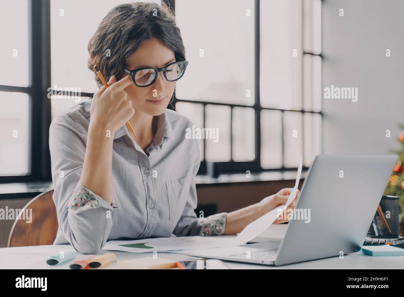 Businesswoman in glasses feeling tired, suffering from eye strain and fatigue during computer work Stock Photo