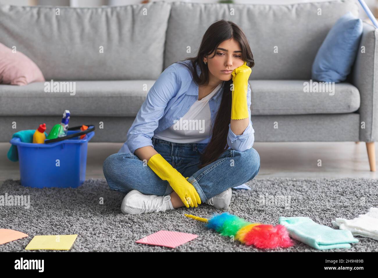 Upset Rug Upset woman tired of cleaning sitting on rug carpet Stock Photo - Alamy