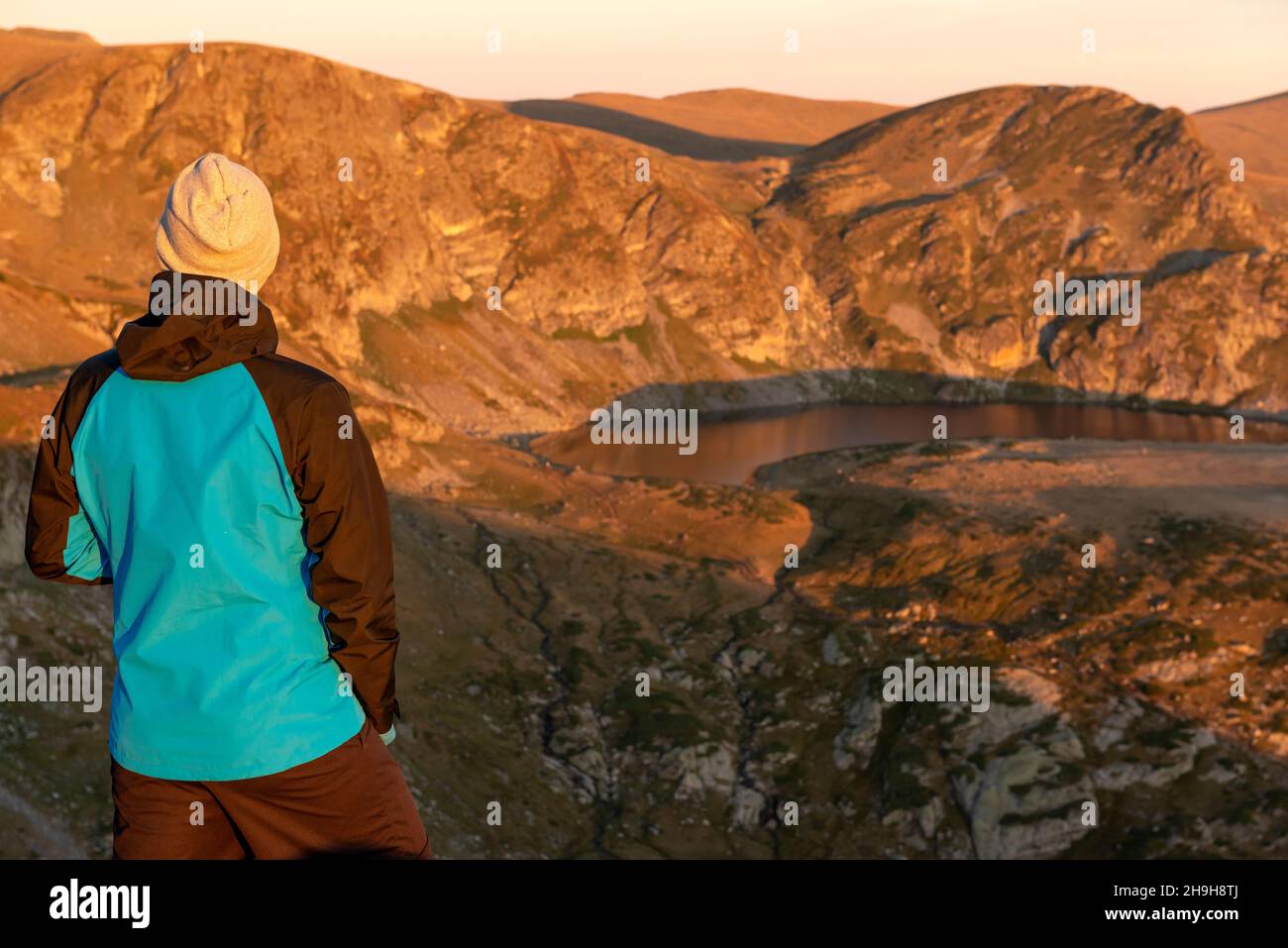 Lone male hiker at the Seven Rila Lakes Circus in sunrise light, Rila Mountain, Bulgaria Stock Photo