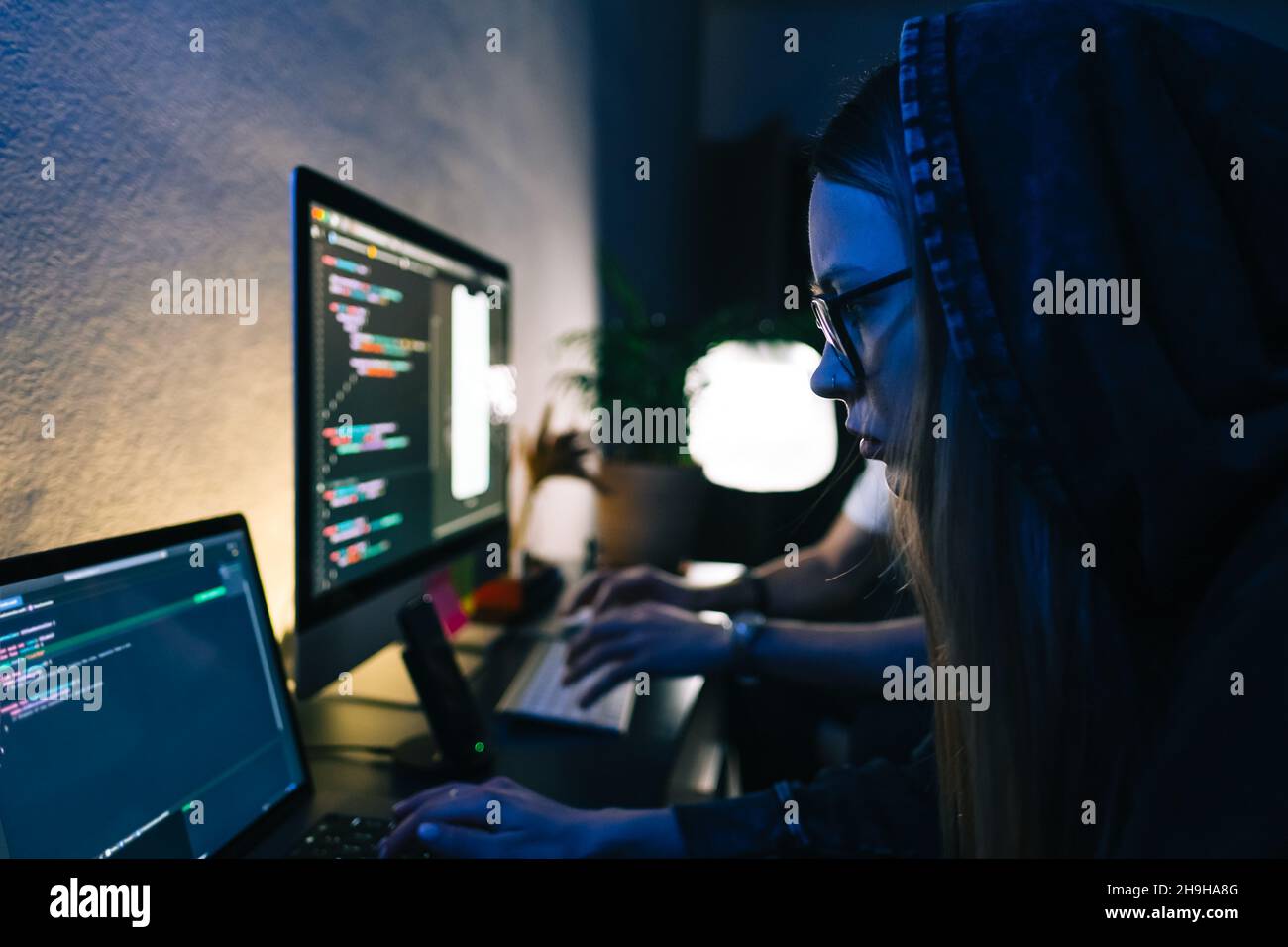 Mobile developers team writes program code on a computer, programmers work in home office. Stock Photo