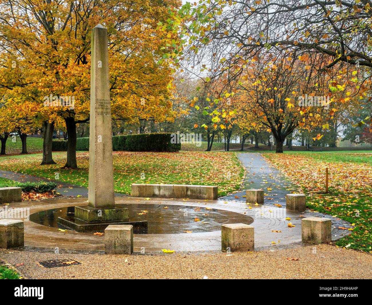 The Flood Obelisk marking the 1866 flood height in Peel Park in Autumn in the City of Salford Greater Manchester England Stock Photo