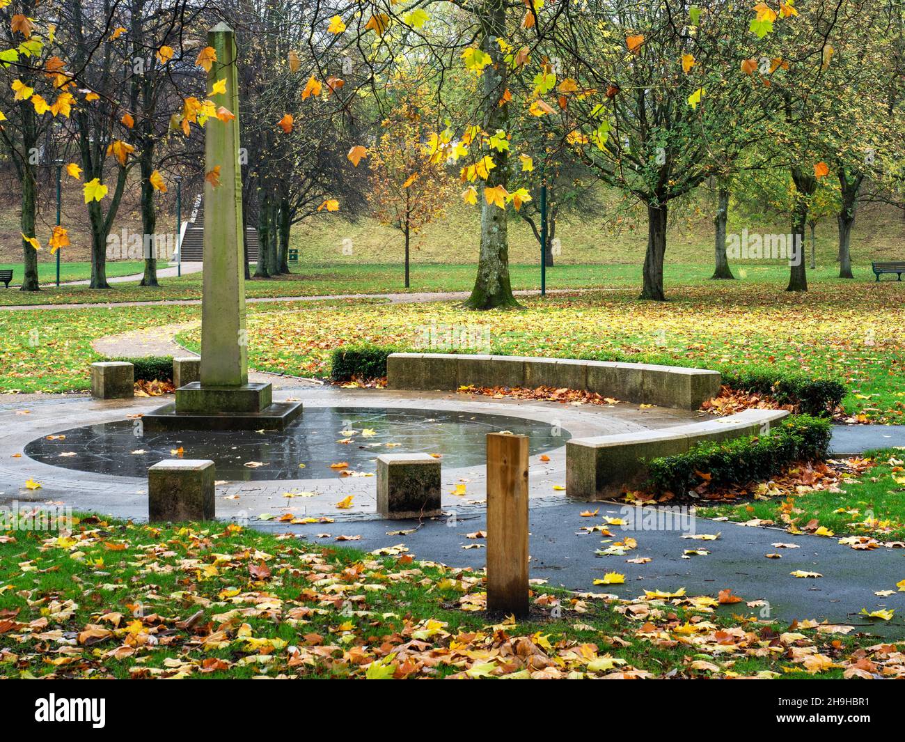 The Flood Obelisk marking the 1866 flood height in Peel Park in Autumn in the City of Salford Greater Manchester England Stock Photo