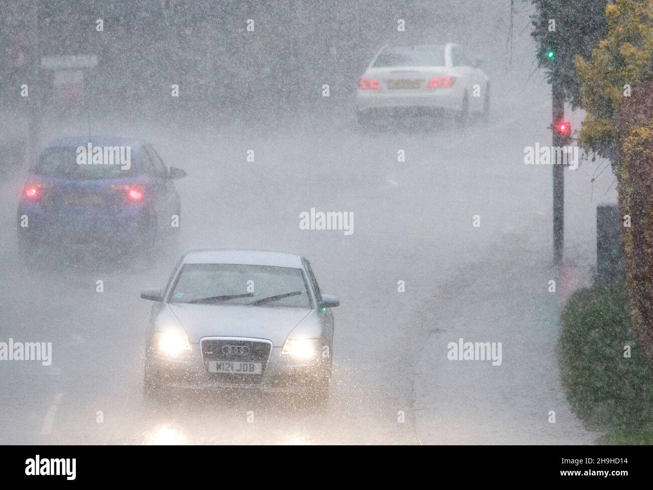 Chippenham, Wiltshire, UK. 7th December, 2021. Drivers are pictured braving torrential rain in Chippenham as storm Barra approaches southern England. Credit: Lynchpics/Alamy Live News Stock Photo