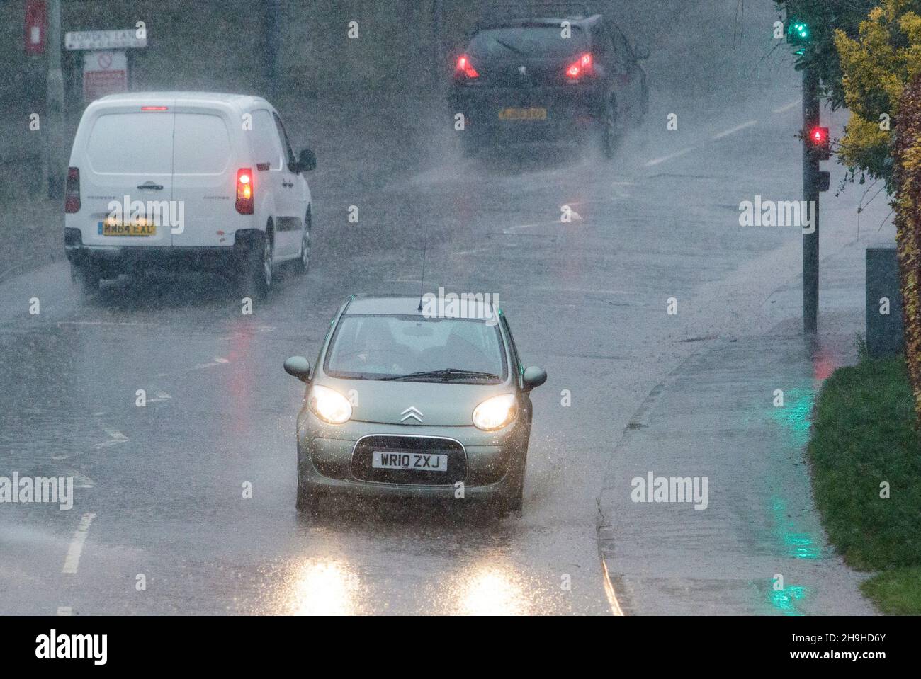Chippenham, Wiltshire, UK. 7th December, 2021. Drivers are pictured braving torrential rain in Chippenham as storm Barra approaches southern England. Credit: Lynchpics/Alamy Live News Stock Photo
