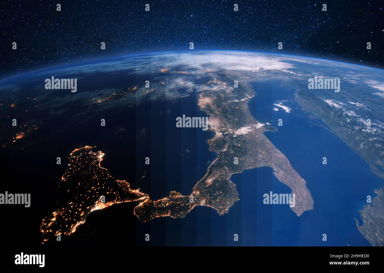 Beautiful blue planet earth with city lights from space on the starry sky. Transition from night to day.  Italy and Central Europe from space Stock Photo