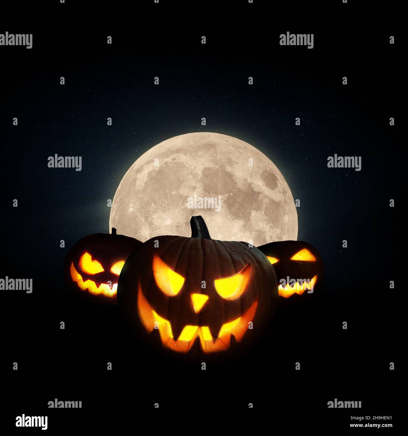 Scary glowing pumpkin with a full moon on a black background. Halloween