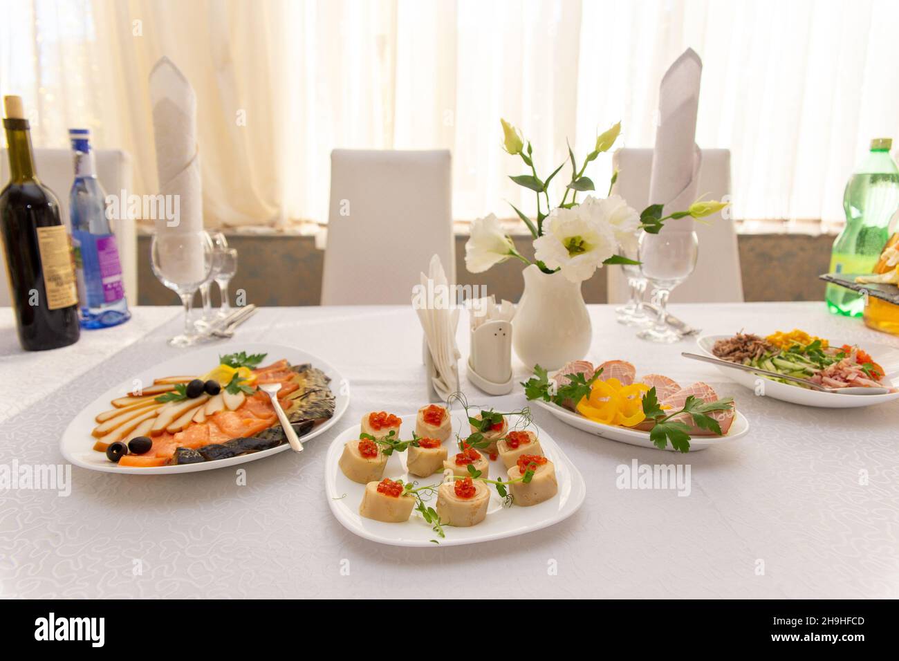 Beautiful table served with glassware and cultery, prepared for festive event. Special occasion celebrted in luxury restaurant or cafe. Table setting Stock Photo