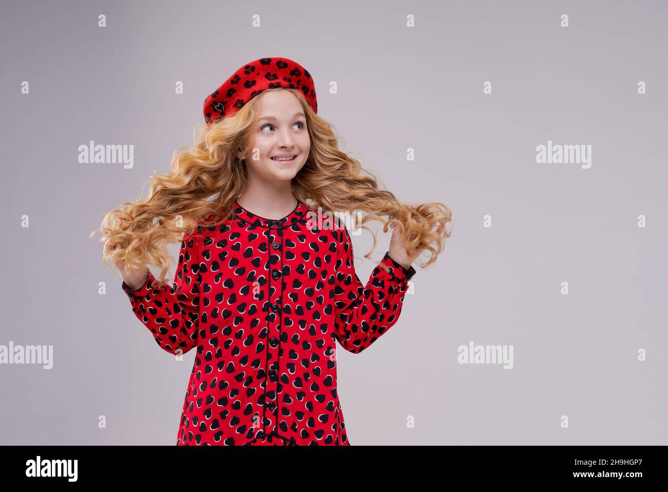 French fashion icon. Happy child wearing french red beret and dress on a light background