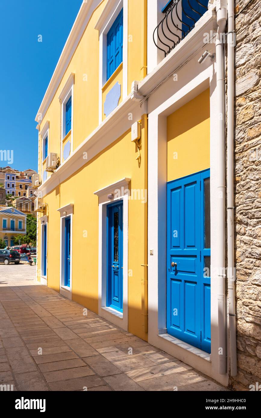 Greek house with blue door and window on Symi island in Greece Stock ...