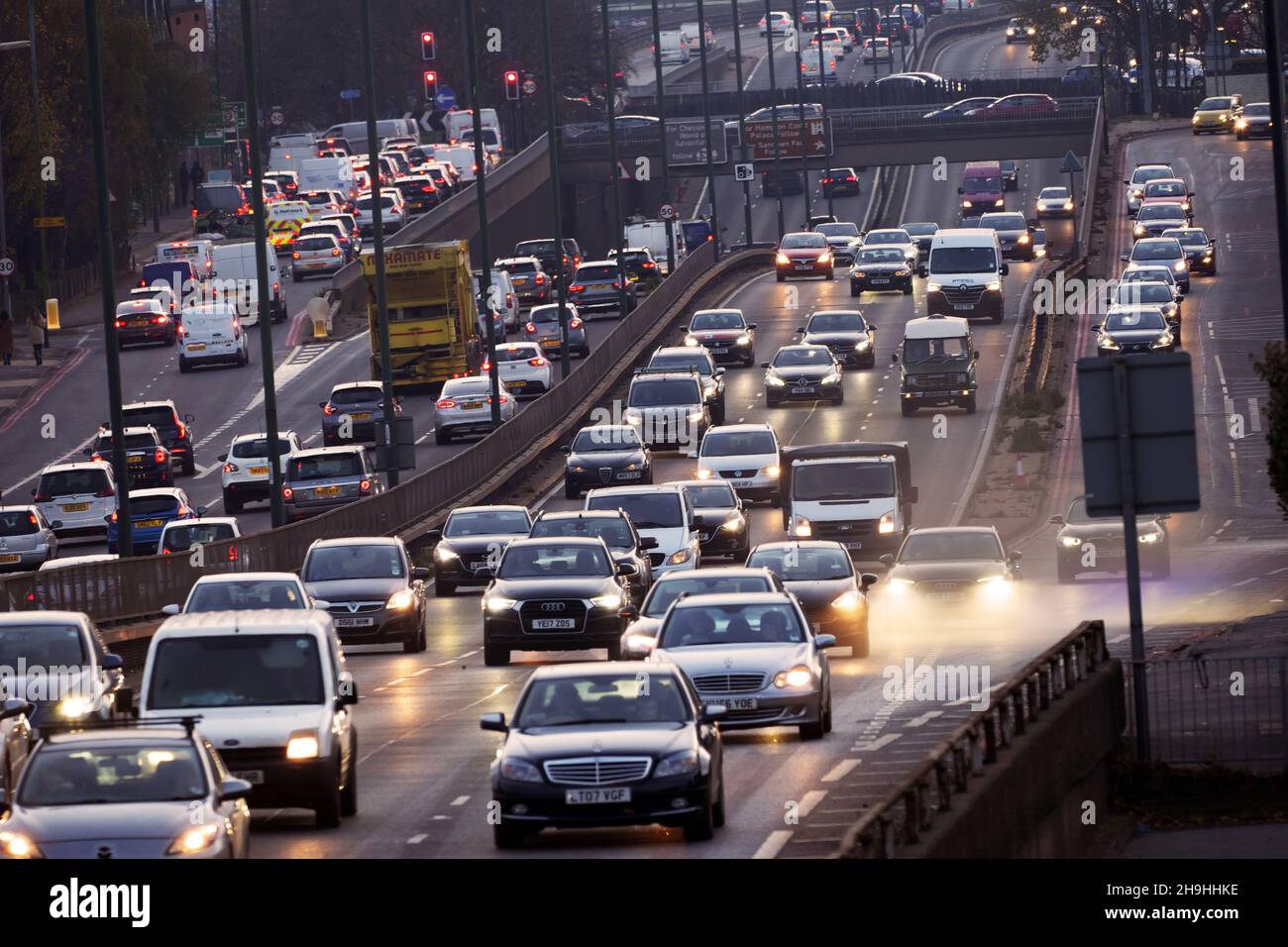 Heavy early evening commuter traffic on the A3 Trunk Road at dusk traveling to and from Central London. Stock Photo