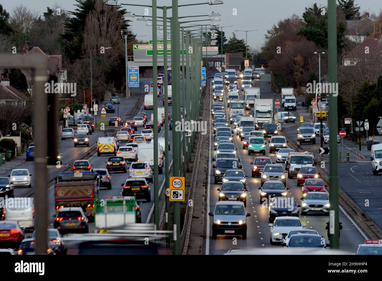 Heavy early evening commuter traffic with headlights on driving along the A3 Trunk Road at dusk in South West London. Stock Photo