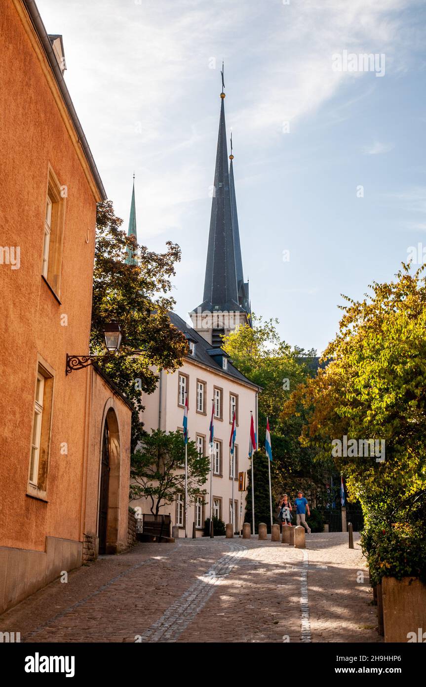Cobbled street and old houses on Place de Clairefontaine with the spires of Notre-Dame cathedral in the historic centre of Luxembourg City. Stock Photo
