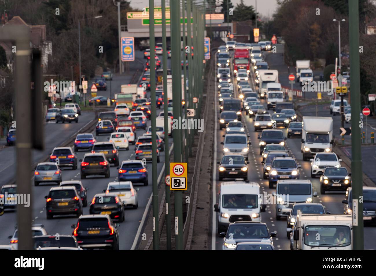 Heavy early evening commuter traffic with car headlights on driving along the A3 Trunk Road at dusk in South West London. Stock Photo