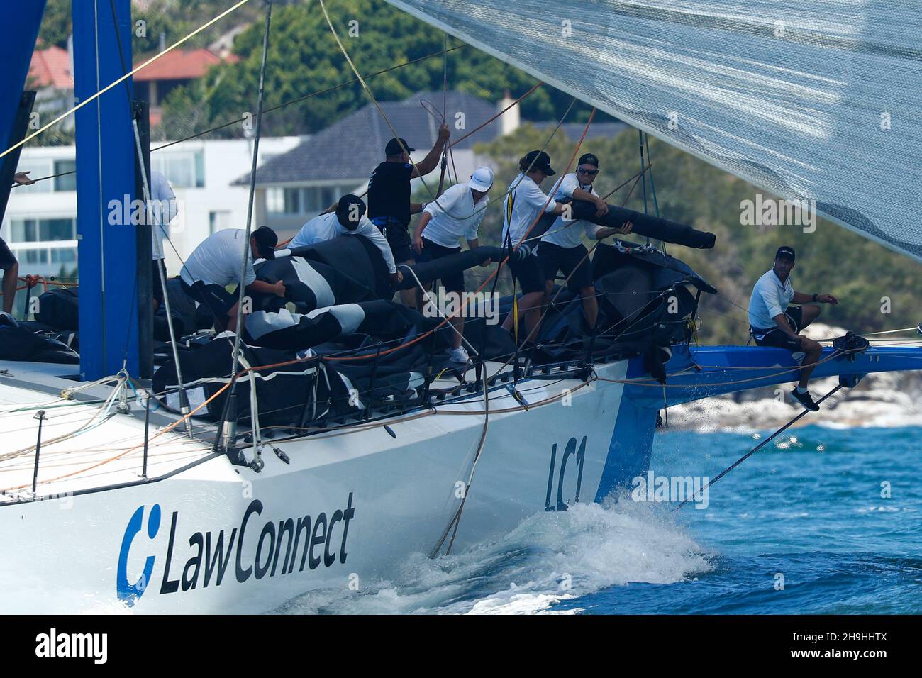 Sydney, Australia. 7th December 2021;  Cruising Yacht Club of Australia, Sydney, NSW, Australia: SOLAS Big Boat Challenge; crew of the maxi yacht LawConnect work on the sail rigging before the start of the race Credit: Action Plus Sports Images/Alamy Live News Stock Photo