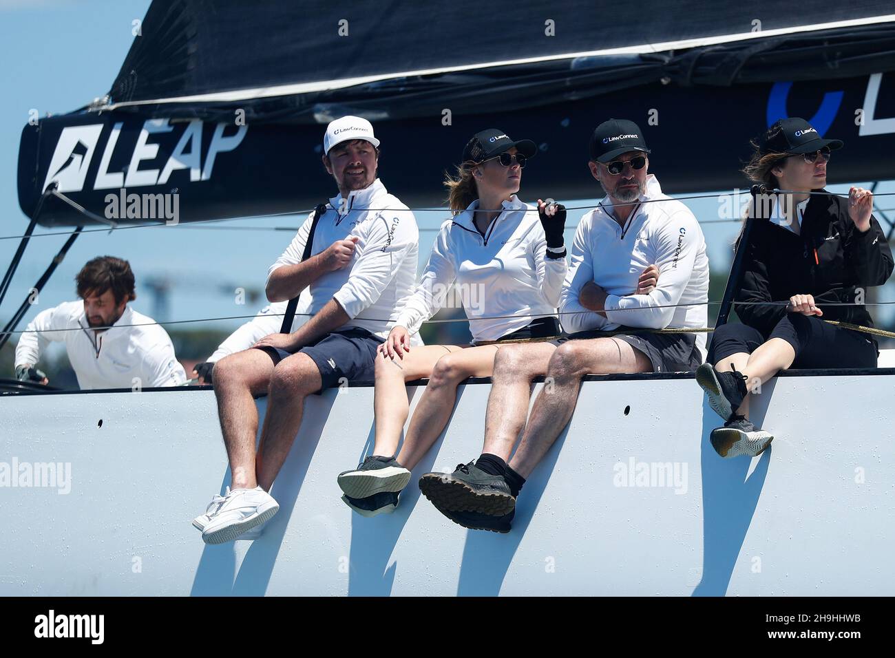 Sydney, Australia. 7th December 2021;  Cruising Yacht Club of Australia, Sydney, NSW, Australia: SOLAS Big Boat Challenge; crew of the maxi yacht LawConnect sitting on the starboard side of the yacht as it races up the harbour to the first turn Credit: Action Plus Sports Images/Alamy Live News Stock Photo