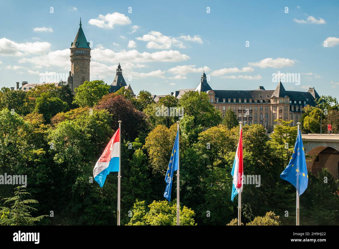 Musée de la Banque (Bank Museum, left) and State Bank and Savings Fund buildings with Luxembourg and EU flags in the foreground, Luxembourg City. Stock Photo