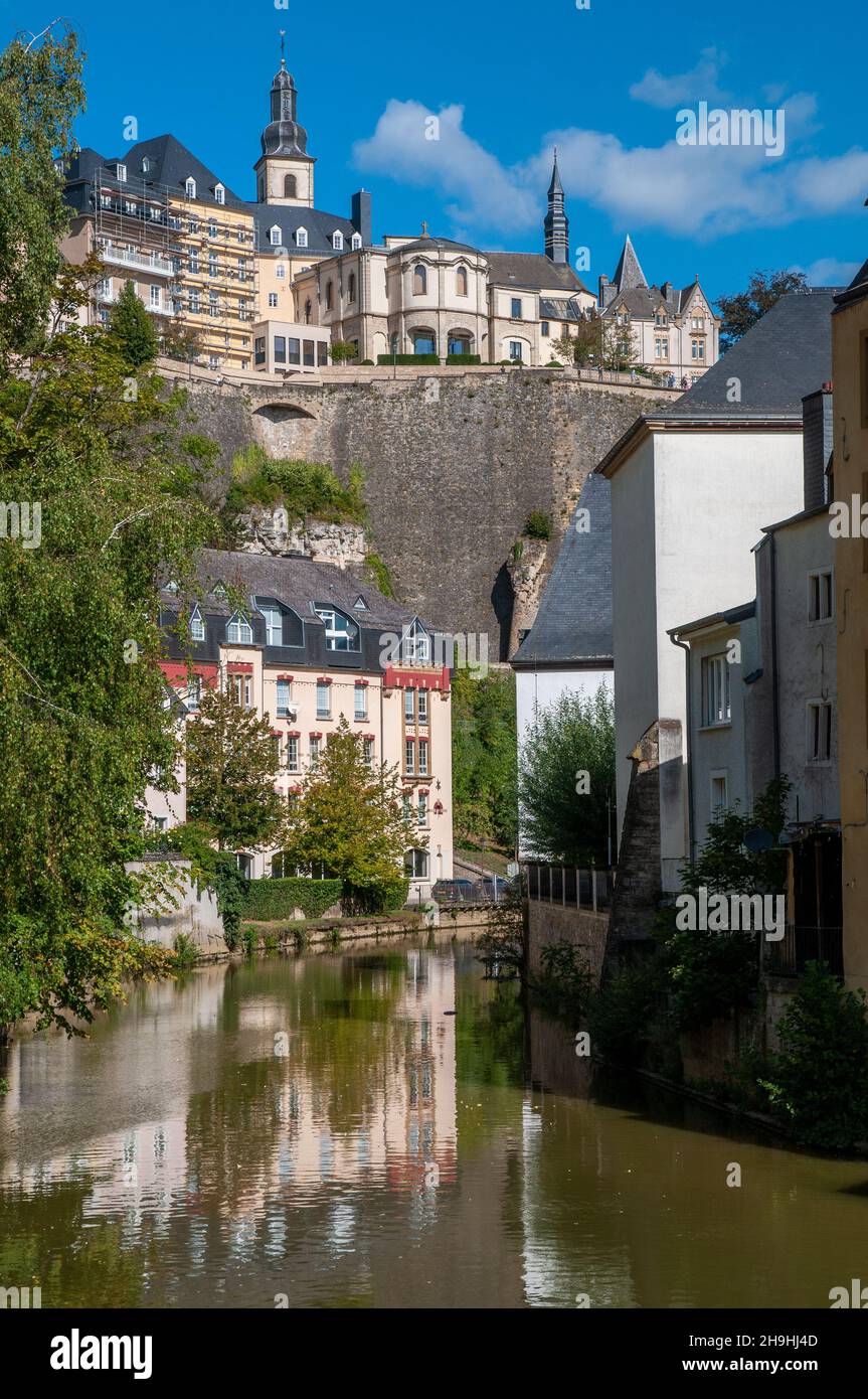 View of the old, historic town of Luxembourg City by the Alzette river in Grund Valley. Stock Photo