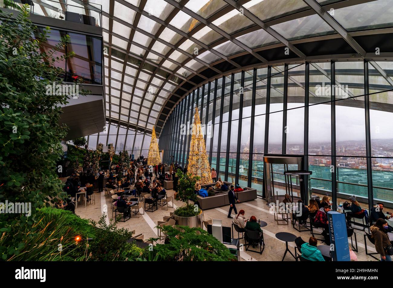 London, England, United Kingdom - December 7, 2021: Wide view of the Sky Garden terrace decorated with Christmas trees and lights in the 20 Fenchurch S Stock Photo