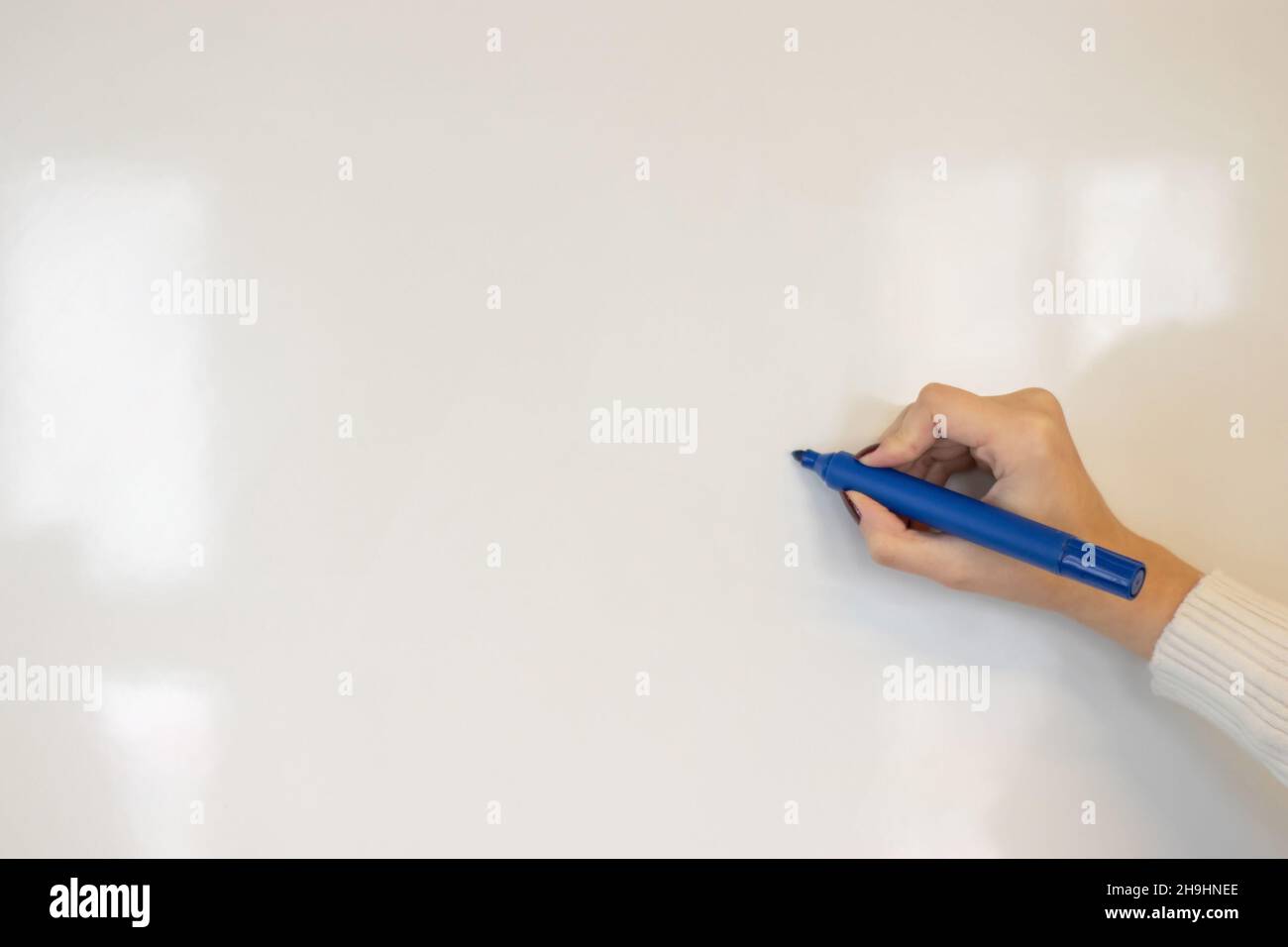 woman writing on whiteboard Stock Photo